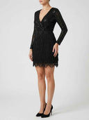 Black sequin mini dress with long sleeves and fringe skirt, angled side view.