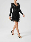 Black sequin mini dress with fringe skirt, angled view on a white background.