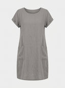 Gray linen mini dress with short rolled sleeves and two front pockets, front view.