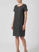 Dark gray linen mini dress with short sleeves and two front pockets, angled view.