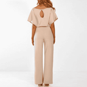 Beige wide-leg jumpsuit with keyhole back, short sleeves, and cinched waist, rear view.