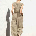 Khaki cotton-linen jumpsuit with button-back top and elastic waist, back view.