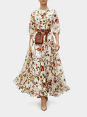 White floral maxi dress with lantern sleeves, brown belt, and pouch, front view.