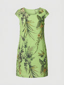 Lime green mini dress with crew neck and tropical leaf print, front view.
