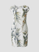 White crew neck mini dress with green and brown botanical print, front view.