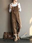 Brown velvet wide-leg overalls with front pockets, worn over a white shirt, front view.