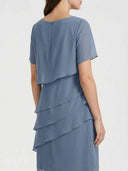 Blue tiered mini dress with short sleeves and back zipper, rear angled view.