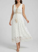 White lace maxi dress with V-neck, tassel tie, and crochet trim, front view.