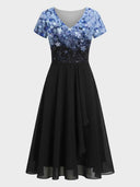 Black maxi dress with blue floral print bodice and V-neck, front view.
