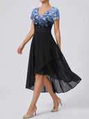 Blue and black floral maxi dress with high-low hem, angled view.