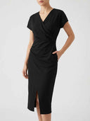 Black V-neck midi dress with cap sleeves, ruched waist, and side slit, angled front view.