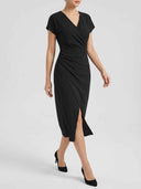 Black V-neck midi dress with ruched side and front slit, angled front view.