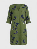 Olive green mini dress with navy leaf print, V-neck, and 3/4 sleeves, front view.