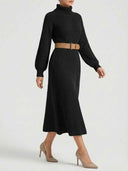 Black ribbed knit turtleneck maxi dress with a tan belt, angled side view.