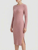 Pink ribbed knit midi dress with cable knit sleeves and side slit, front view.