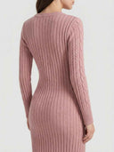 Pink ribbed knit midi dress with cable knit sleeves, back angled view.
