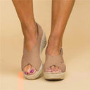 Brown tan cross-strap espadrille wedge sandals with smooth fabric upper and woven jute rope wedge sole, front view.
