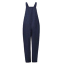 Navy blue jumpsuit with wide straps, loose fit, and tie waist, front view on white background.
