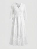 White long sleeve mini dress with lace trim and polka dots, front view.