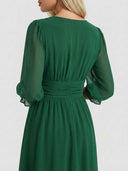 Green mini dress with sheer long sleeves and ruched waist detail, back angled view.