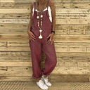 Maroon denim overalls with white tank top, long necklace, and white sneakers, front view.