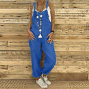 Blue denim overalls with a white tank top and beaded necklace, front view.