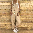 Tan linen overalls with white top, star necklace, and white sneakers, front view.
