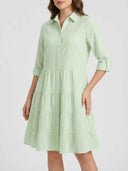 Light green and white striped tiered mini dress, front view.