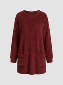 Red fuzzy knit mini dress with long sleeves and two front pockets, front view.