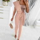 Peach one-shoulder jumpsuit with sequined bodice and waist tie, front view in a room.