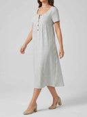 White and gray striped midi dress with short sleeves and button front, angled view.