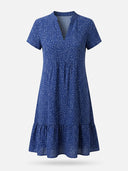 Blue short-sleeved dress with white speckles, V-neck, and ruffled hem, front view.