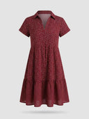 Red collared dress with white polka dots, short sleeves, and tiered skirt, front view.