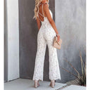 White lace jumpsuit with criss-cross back straps, angled rear view.