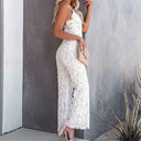 White lace jumpsuit with spaghetti straps, side view against a gray wall.