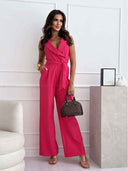 Fuchsia sleeveless jumpsuit with V-neck and waist tie, front view on a white background.