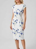 White maxi dress with blue floral print, twisted waist detail, front view.