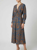 Blue maxi dress with brown floral print, V-neck, and twisted front detail, front view.