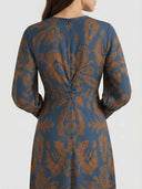 Blue maxi dress with brown abstract pattern, back view.