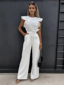 White ruffled sleeve jumpsuit with coordinating waist belt, front view against a dark background.