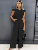 Black ruffled sleeve jumpsuit with coordinating waist belt, front view.