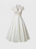 White midi dress with lace bodice, V-neck, short sleeves, and satin A-line skirt, front view.