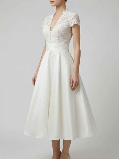 White A-line midi dress with lace bodice, satin waistband, and V-neck, angled front view.