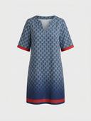 Blue mini dress with white logo print, V-neck, short sleeves with red cuffs, and red hem stripe, front view.