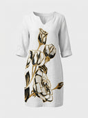 White mini dress with black and gold floral print, V-neck, and 3/4 sleeves, front view.