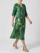 Green floral mini dress with gold accents, V-neck, and rolled sleeves, angled view on white background.
