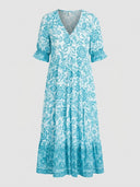 Light blue and white floral V-neck maxi dress with tiered skirt, front view.
