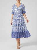 White and blue floral maxi dress with V-neck and ruffled sleeves, front view.