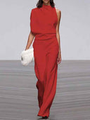 Red sleeveless crew neck jumpsuit with wide legs, front view on a runway.