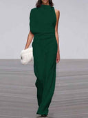 Dark green sleeveless crew neck jumpsuit with wide legs, front view on a light gray background.